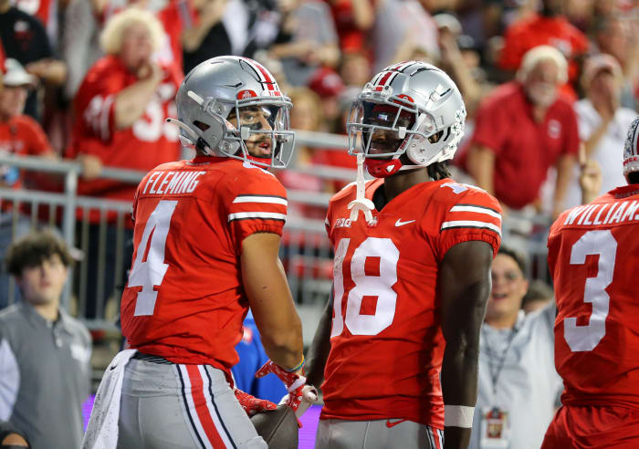 Ohio State wide receivers Julian Fleming (No. 4) and Marvin Harrison Jr. (No. 18) celebrate a touchdown against Toledo.